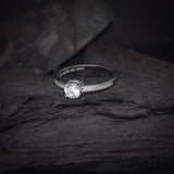 Anillo de compromiso con diamante natural central de .50ct corte brillante y 16 diamantes naturales laterales elaborado en oro blanco de 14k