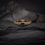 Anillo de compromiso con zafiro natural de .50ct corte brillante y 24 cristales laterales elaborado en oro amarillo de 14k