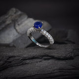 Anillo de compromiso con zafiro natural de .50ct corte brillante y 48 diamantes laterales elaborado en oro blanco de 14k