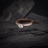 Anillo de compromiso con diamante natural central de .50ct corte brillante con certificación GIA y 10 cristales laterales elaborado en oro rosa de 14k