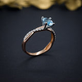 Anillo de compromiso con topacio natural de 1.0ct corte brillante y 18 diamantes naturales laterales elaborado en oro rosa de 14k