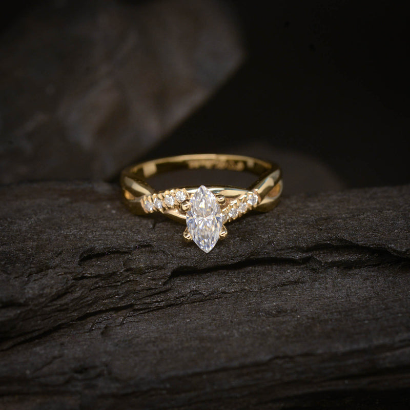 Anillo de compromiso con moissanita de .50ct corte marquise con certificado GRA y 8 diamantes naturales laterales elaborado en oro amarillo de 14 kilates
