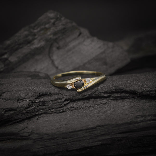 Anillo de compromiso con diamante negro natural de .20ct y 2 diamantes laterales elaborado en oro amarillo de 14 kilates