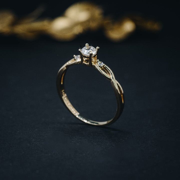 Anillo de compromiso con diamante natural de .20ct y 2 diamantes laterales elaborado en oro amarillo de 18 kilates