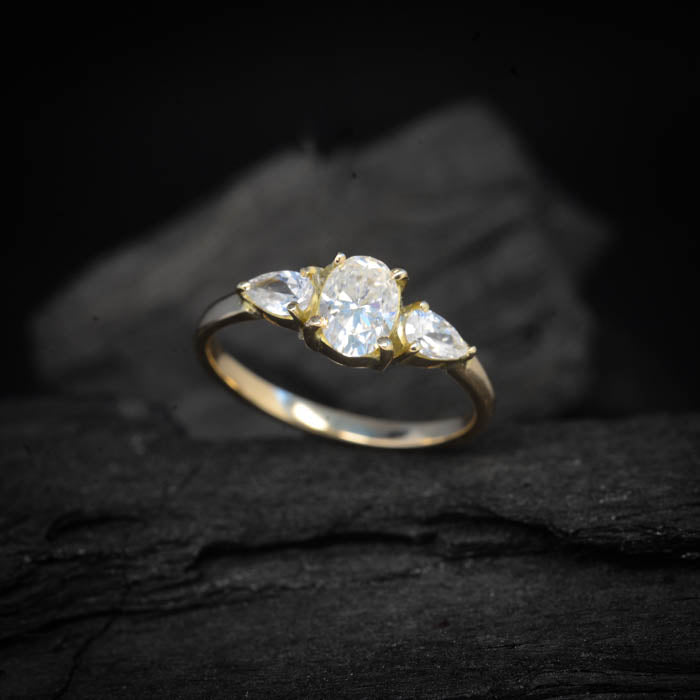 Anillo de compromiso con moissanita oval de 1.5ct con certificado GRA y moissanitas laterales elaborado en oro amarillo de 14 kilates