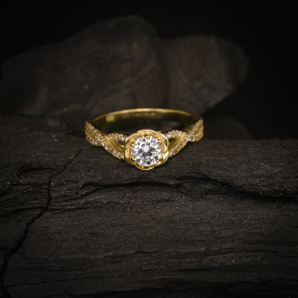 Anillo de compromiso con diamante natural central de .50ct con certificación GIA y cristales laterales elaborado en oro amarillo de 14 kilates