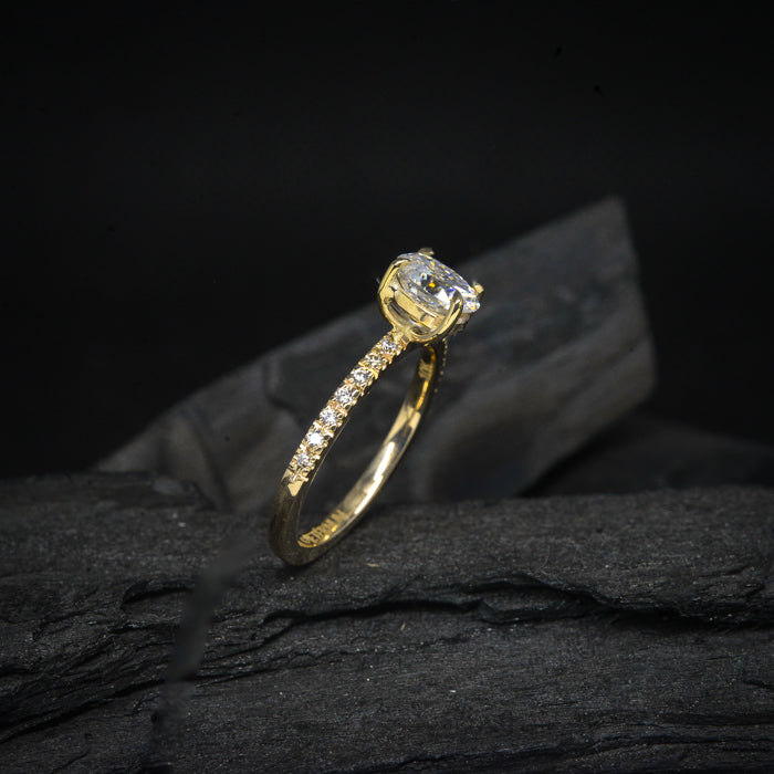 Anillo de compromiso con moissanita oval de 1.0ct con certificado GRA y moissanitas laterales elaborado en oro amarillo de 14 kilates