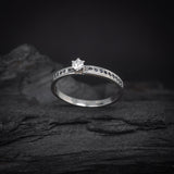 Anillo de compromiso con diamante natural de .20ct y 18 zafiros laterales elaborado en oro blanco de 14 kilates
