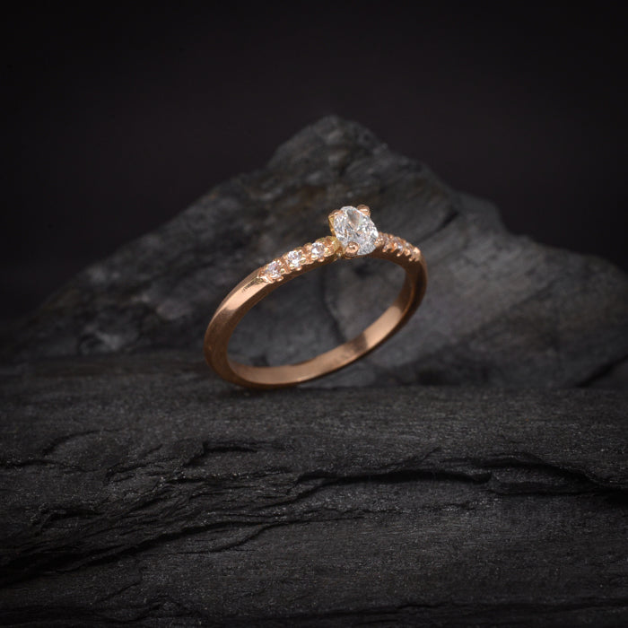 Anillo de compromiso con diamante natural central de .30ct corte oval con certificación GIA y 6 diamantes naturales laterales elaborado en oro rosa de 18 kilates