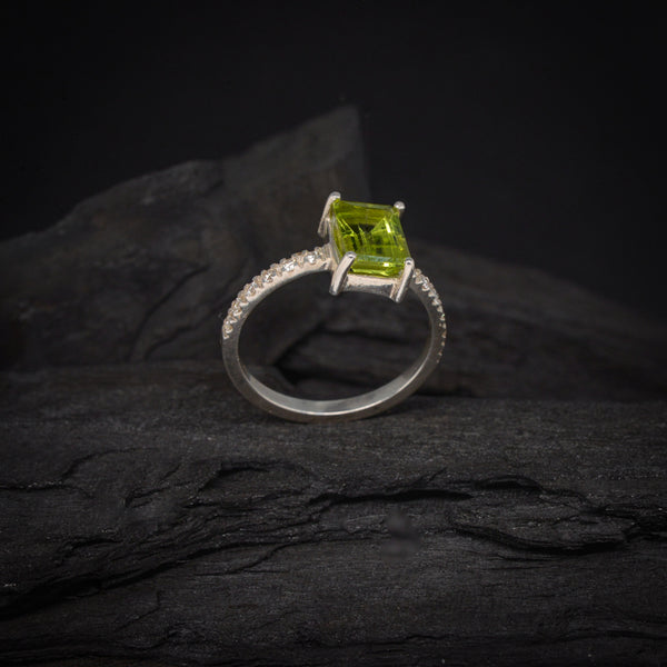 Anillo de compromiso con peridoto natural y 12 diamantes laterales elaborado en oro blanco de 14 kilates