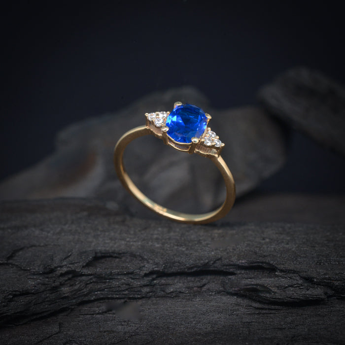 Anillo de compromiso con zafiro natural y 6 diamantes laterales elaborado en oro amarillo de 14 kilates