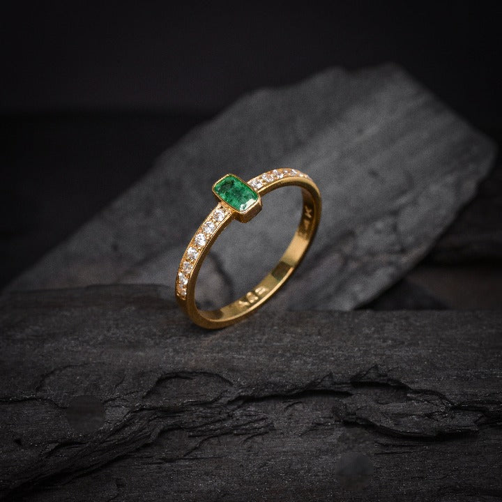 Anillo de compromiso con esmeralda natural y 14 diamantes laterales elaborado en oro amarillo de 14 kilates