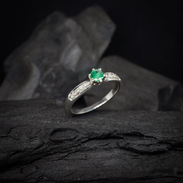 Anillo de compromiso con esmeralda natural y 10 diamantes laterales realizado en oro blanco de 14 kilates