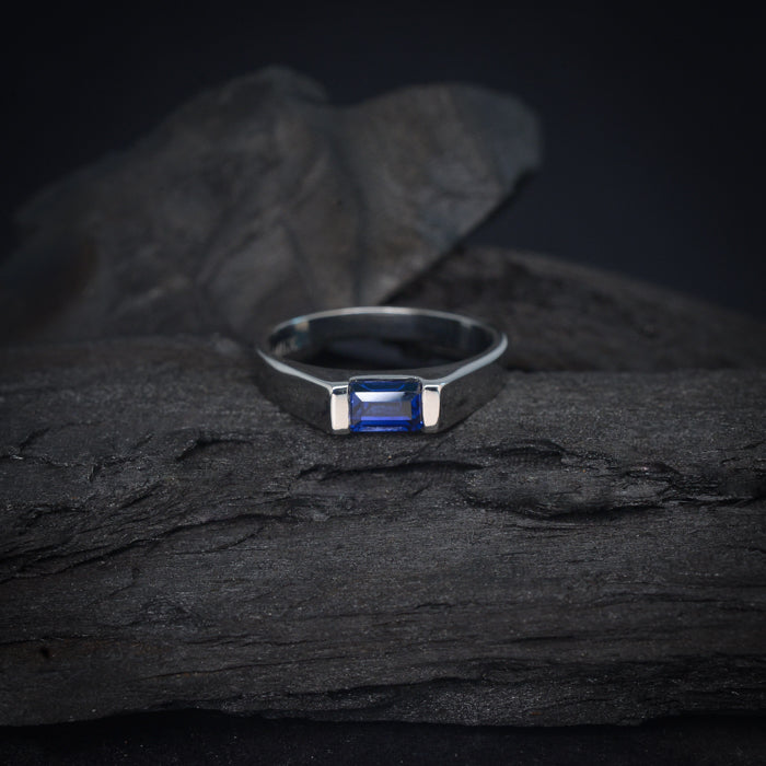 Anillo de compromiso con zafiro natural de .60ct corte esmeralda elaborado en oro blanco de 14k