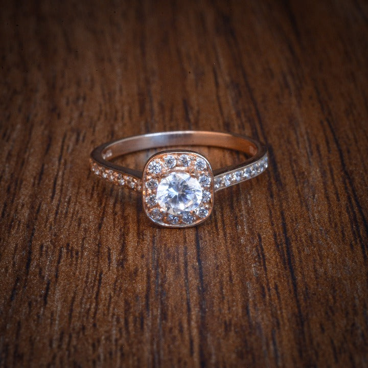 Anillo de compromiso con diamante natural de .25ct y 26 diamantes laterales realizado en oro rosa de 14 kilates