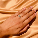 Anillo de compromiso con esmeralda natural y 10 diamantes laterales realizado en oro blanco de 14 kilates